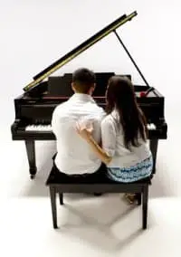 A couple sharing a piano bench